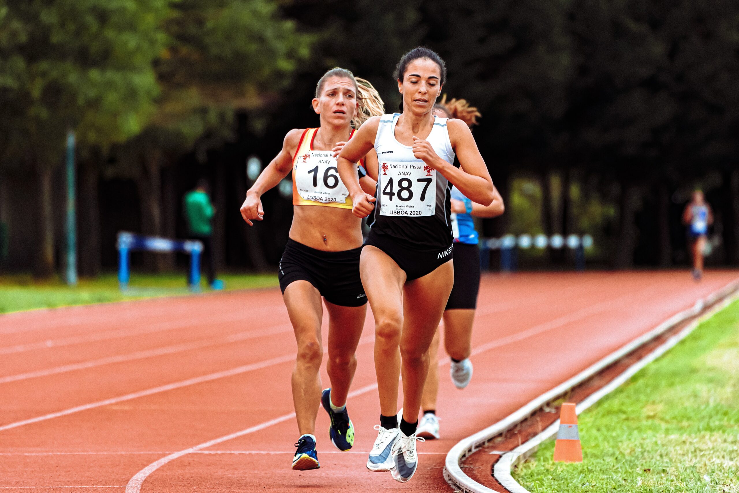 Three women racers run on track